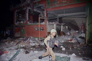 An army soldier examines a building damaged by a suspected Indian missile attack near Muzaffarabad, the capital of Pakistan-controlled Kashmir, on Wednesday, May 7, 2025